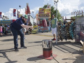 Saskatoon StarPhoenix reporter Matt Olson tries the Hammer Strength at the Saskatoon Ex at Prairieland Park in Saskatoon, Sask. on Friday, August 11, 2017.