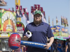 Star Phoenix reporter Matt Olson with his prizes from carnival games at the Saskatoon Ex at Prairieland Park in Saskatoon, Sask. on Friday, August 11, 2017.