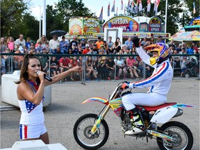 Angelina Nock introduces Brad Keogh to the crowd before he begins his stunts at the Saskatoon Exhibition.