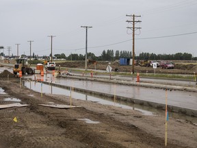 Workers attempt to control flooding at the intersection of Garvie Road and Central Avenue in Saskatoon, SK on Monday, August 14, 2017. A contractor working in the area punctured a water main which has resulted in significant localized flooding.