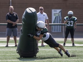 BESTPHOTO  SASKATOON,SK--AUGUST 18/2017-0819 Sports Football Robot-  Saskatoon Valkyries #22 Samantha Matheson tackles a robotic tackling dummy during a media event at SMF Field in Saskatoon, SK on Wednesday, August 18, 2017. David Dube has purchased a robotic tackling dummy that runs 20 miles an hour and is designed to train football players while reducing concussions.(Saskatoon StarPhoenix/Liam Richards)
Liam Richards, Saskatoon StarPhoenix