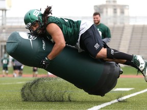 Eric Thakurdeen tackles during the University of Saskatchewan Huskies football practice at Griffiths Stadium in Saskatoon on August 20, 2017.