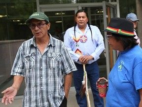 From left to right, Archie Nicotine, Alvin Baptiste and Debbie Baptiste, members of Red Pheasant First Nation, rally outside Saskatoon Court of Queen's Bench on Aug. 22, 2017 as lawyers discuss how to handle allegations of chief and councillor vote buying in the band's last election.