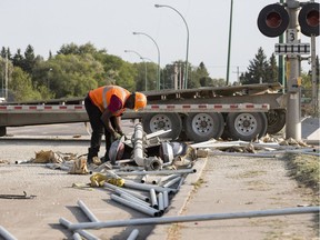 Saskatoon police and CP Rail employees on the scene of a collision between a train and a truck at the intersection of Fairlight Drive and 11th Street West in Saskatoon, SK on Wednesday, August 23, 2017. No injuries were reported, but debris was scattered all over the roadway.