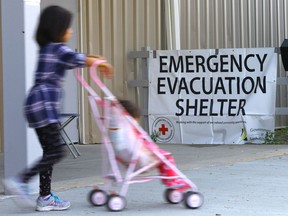 Pelican Narrows evacuees hang outside the emergency evacuation shelter at Henk Ruys Soccer centre in Saskatoon on August 30, 2017. (Michelle Berg / Saskatoon StarPhoenix)