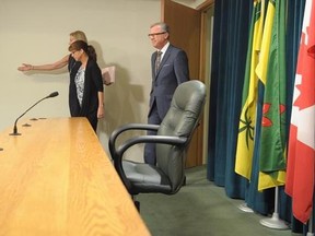 Premier of Saskatchewan Brad Wall, his wife Tami, and chief of operations and communications Kathy Young, back, enter a press conference where Wall announced he is retiring from politics at the Legislative Building in Regina, Sask., on Thursday, August 10, 2017. THE CANADIAN PRESS/Mark Taylor