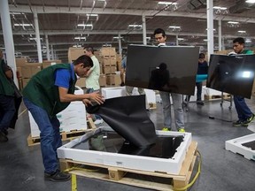 FILE - In this March 23, 2017 file photo, workers inspect and pack LG flat screens at an assembly plant in Reynosa, Mexico. The Trump administration is pressing to bring labor and environmental regulations into the main body of the North American Free Trade Agreement text in the upcoming renegotiation of the three-way trade pact set for Aug. 16, in Washington, D.C. (AP Photo/Rodrigo Abd, File)