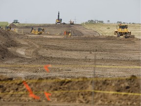 Workers assemble an Enbridge pipeline near Hardisy, Alberta.