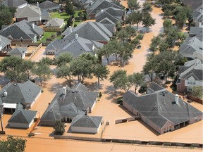 Homes are surrounded by floodwater after torrential rains pounded Southeast Texas following Hurricane and Tropical Storm Harvey on August 31, 2017 near Sugar Land, Texas. Harvey, which made landfall north of Corpus Christi August 25, has dumped nearly 50 inches of rain in and around Houston. (Photo by Scott Olson/Getty Images)