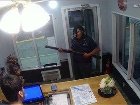 Security footage showing a man wielding a projector screen as a makeshift weapon during an attempted robbery at a business in North Battleford on Tuesday. (Photo courtesy Battleford RCMP)