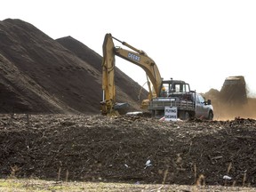The City of Saskatoon is considering major changes to how it manages waste, including a mandatory city-wide compost collection program and a user-fee system for trash collection. Here, machines manage the material at the city's former compost depot on McOrmond Road in 2014. (GORD WALDNER/The StarPhoenix)