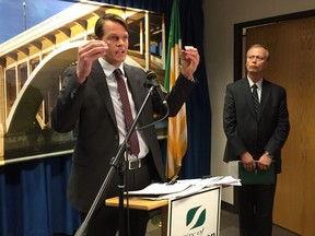 Saskatoon Mayor Charlie Clark speaks at a news conference at city hall on Tuesday, Aug. 29, 2017, about the need to find cost savings to avoid another big property tax increase in 2018, while city manager Murray Totland looks on.