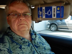 Bill Fuller poses in his car with his disabled parking permit in Warman on August 25, 2017. Jonathan Charlton/Saskatoon StarPhoenix