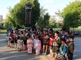 Children from the Japanese Children's Choir sing at the Peace Monument in Rotary Park during a memorial to victims of Hiroshima and Nagasaki in 2014.