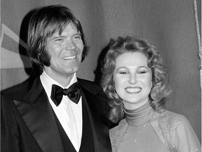 In this Feb. 15, 1979 file photo, country singers Glen Campbell, left, and Tanya Tucker, engaged to one another, are shown at the Grammy Awards in Los Angeles. Campbell, the grinning, high-pitched entertainer who had such hits as "Rhinestone Cowboy" and spanned country, pop, television and movies, died Tuesday, Aug. 8, 2017. He was 81. Campbell announced in June 2011 that he had been diagnosed with Alzheimer's disease.