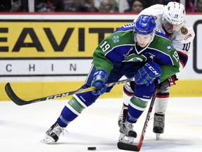 Swift Current Broncos Lane Pederson and Regina Pats Jonathon Smart fight for the puck in Regina.