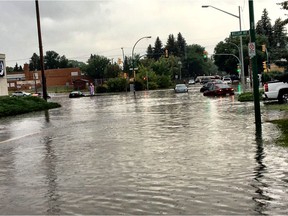 Cars are stranded Tuesday at the intersecction of Taylor Street and Broadway Avenue after a non-hour rain storm hit Saskatoon.