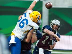 Saskatoon Hilltops defensive end Tom Schnitzler (56), shown here getting a hand up on Regina Rifles QB Sawyer Buettner, is a leader on defence for the CJFL champions