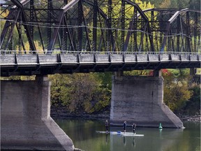 SASKATOON,SK--JULY 24/2015-- Three paddle boarders go under the Traffic Bridge on a sunny day on the river,  Thursday, September. (Greg Pender/The StarPhoenix) Victoria Bridge
Greg Pender, The StarPhoenix