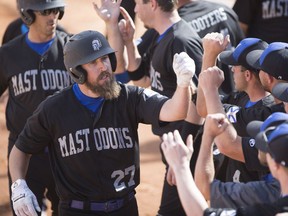 Nova Scotia Mastodons Nick Shailes celebrates with his team after a home-run during the Canadian men's fast-pitch championship at Bob Van Impe Field in Saskatoon,on Sunday, September 3, 2017.