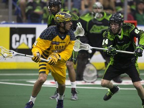 Ryan Dilks (right), defending Georgia's Lyle Thompson during the NLL championship final, is happy to hear his Saskatchewan Rush are getting new turf this season.