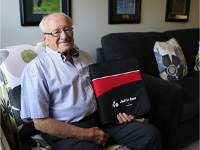 Harold Empey holds a "Just in Case" binder, which contains everything you need to know to help your loved ones when you die. (Michelle Berg / Saskatoon StarPhoenix)