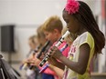 Grade Five students play Oh Canada prior to country artist Jess Moskaluke, not pictured, performing at  L'ƒcole Canadienne Francaise during an event to announce the donation of musical instruments and equipment though the MusiCounts Band Aid Program in Saskatoon, September 8, 2017.