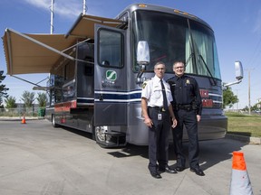 Saskatoon Fire Chief Morgan Hackl, left, and Saskatoon Police Services Superintendent Mitch Yuzdepski stand for a photograph during an event to display a new mobile command vehicle at Fire Station No. 9 in Saskatoon, SK on Tuesday, September 12, 2017.