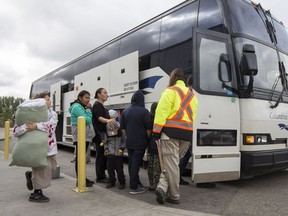 Residents of the Pelican Narrows area, who had been evacuated due to fire, load on to buses to return home at the Henk Ruys Soccer centre in Saskatoon, SK on Thursday, September 14, 2017. The soccer centre had been being used as an emergency evacuees shelter.