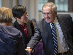 University of Saskatchewan Chancellor Roy Romanow, right, shakes hands while College of Nursing Dean Huey-Ming Tzeng, left, looks on during a panel on the future of healthcare in Canada at Convocation Hall on the U of S campus in Saskatoon, Sask. on Monday, Sept. 18, 2017.