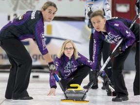 Amber Holland (centre) watches her rock's path as Laura Strong and Deb Lozinski sweep during the Colonial Square Ladies Curling Classic.