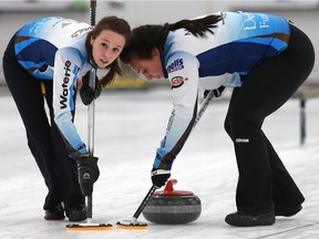 Sheyna Andres (left) and Mariah Mondor, who play with skip Shannon Birchard, sweep during Sunday's Colonial Square Ladies Curling Classic win over Jennifer Jones.