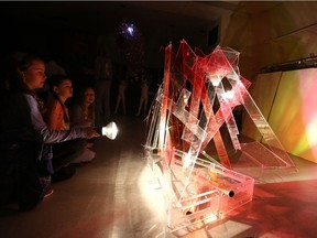 Grade 5 students Amalia Janzen (from left), Annabel Murton and Kaitlyn Helgason help build light-based sculptures and projections for Nuit Blanche Saskatoon.