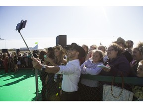 Aaron Pritchett takes a photo with fans down on the CCMA Green Carpet at SaskTel Centre on Sept. 10, 2017.