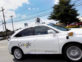 In this May 13, 2015 file photo, Google&#039;s self-driving Lexus car drives along street during a demonstration at Google campus in Mountain View, Calif. About half of Canadian consumers surveyed say they trust autonomous vehicles to get them to their destination but only 30 per cent would replace their current vehicle with a self-driving car. THE CANADIAN PRESS/AP/Tony Avelar, File