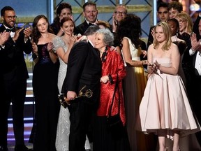 Bruce Miller, from left, Margaret Atwood, and Elisabeth Moss accept the award for outstanding drama series for &ampquot;The Handmaid&#039;s Tale&ampquot; at the 69th Primetime Emmy Awards in Los Angeles on Sunday, Sept. 17, 2017. The Canadian literary community is celebrating the success of the series &ampquot;The Handmaid&#039;s Tale,&ampquot; which is based on Toronto author Margaret Atwood&#039;s 1985 dystopian novel. THE CANADIAN PRESS/AP-Invision, Chris Pizzello