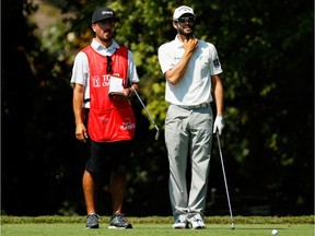 Adam Hadwin of Canada and his caddie prepare to play his shot from the second tee during the first round of the TOUR Championship at East Lake Golf Club on September 21, 2017 in Atlanta, Georgia.