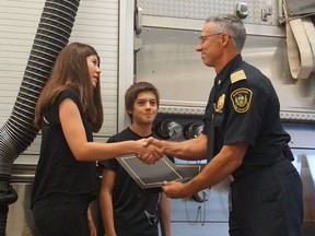 After their quick thinking was able to help three people escape from a burning home on Sunday August 27, Colson and Ami Klinger, along with their father Dave (not pictured,) were honoured by fire chief Morgan Hackl and the Saskatoon Fire Department for their efforts on September 1, 2017.