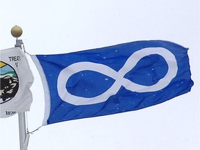 A Metis flag flies in the wind in this Postmedia News file photo. The treasurer of the Metis Nation — Saskatchewan is refuting a claim that she resigned her position.