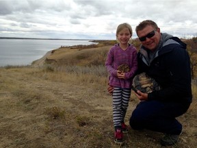 Lily Ganshorn and her father Jon show off some of the favourite fossils they uncovered during their summer excavations at Lake Diefenbaker. (Supplied photo/ Jon Ganshorn)