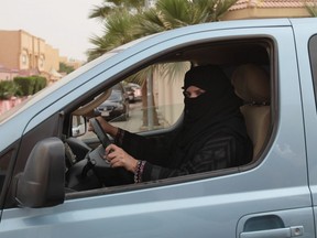 In this Saturday, March 29, 2014 file photo, A woman drives a car in Riyadh, Saudi Arabia as part of a campaign to defy Saudi Arabia's ban on women driving.