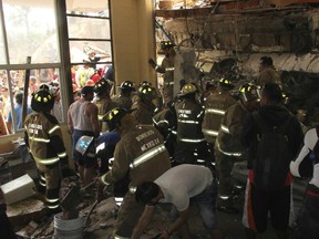 Rescue workers search for children trapped inside the collapsed Enrique Rebsamen school in Mexico City, Tuesday, Sept. 19, 2017.