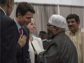 Prime Minster Justin Trudeau, left, shakes hands with Imam Sheikh Ilya Sidyot during Eid al-Adha at Prairieland Park in Saskatoon, Friday, September 1, 2017. THE CANADIAN PRESS/Liam Richards