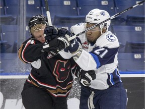 Saskatoon Blades forward Lukus MacKenzie collides with Calgary Hitmen defender Micheal Zipp during first-period WHL action in Saskatoon on Tuesday, January 10, 2017.