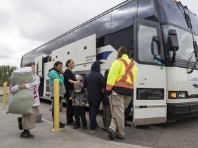 Residents of the Pelican Narrows area, who had been evacuated due to fire, load on to buses to return home at the Henk Ruys Soccer centre in Saskatoon, Sask. on Thursday, Sept. 14, 2017. A councillor in Prince Albert, which housed more than 1,700 evacuees over the summer, says while his motion calling for permanent evacuee infrastructure in the city was defeated at council, it's not dead yet.