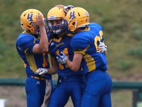 Saskatoon Hilltops' Ryan Turple (right) celebrates his touchdown during the Canadian Junior Football League semifinal against Vancouver Island Raiders at SMF Field in Saskatoon on October 29, 2017.