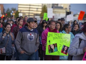 eople walk during the annual Sisters in Spirit walk and vigil hosted by Iskwewuk Ewichiwitochik (Women Walking Together) on 25th Street East in downtown Saskatoon on Wednesday, Oct. 4, 2017.