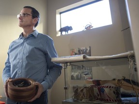Darryl Isbister, public division's co-ordinator of the public division's First Nation, Inuit and Metis education unit, stands holding a bowl used in smudge ceremonies.
