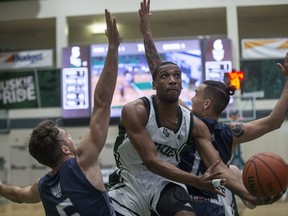 SASKATOON,SK--OCT 12 2017-1012-SPORTS-HUSKIES BASKETBALL- Huskies guard Lawrence Moore moves the ball against the Mount Royal Cougars forward Ryan Cunningham and guard Glen Yang (R) during the game at the PAC facility in Saskatoon, SK on Thursday, October 12, 2017. (Saskatoon StarPhoenix/Kayle Neis)
Kayle Neis, Saskatoon StarPhoenix
