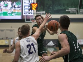 Huskies point guard Alex Unruh (C) goes to pass the pass to forward Sebastien Turcotte during the Ron and Jane Graham Shootout at the PAC in Saskatoon on Saturday, October 14, 2017.